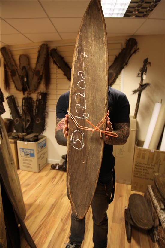 A Sepik River archers shield, another shield and three carved boards
